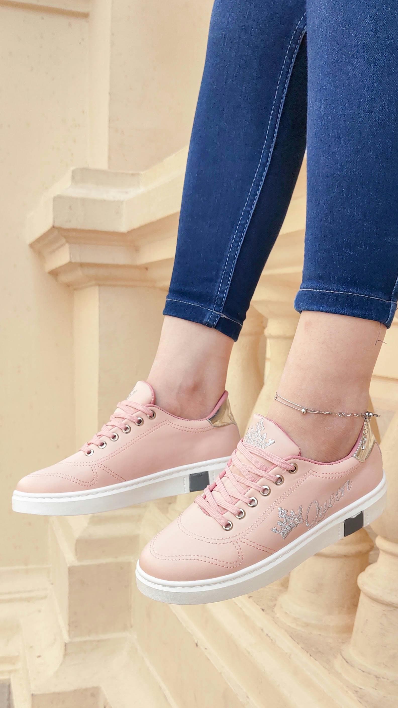 A person holding a food delivery bag next to a car, ready to make a delivery.